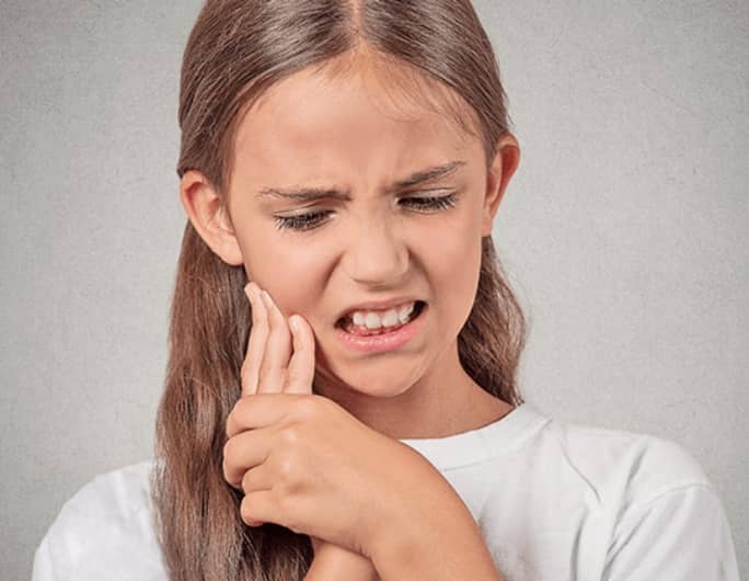 young girl with jaw pain
