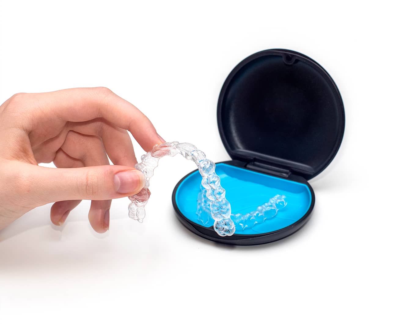 Case and hand holding an invisalign